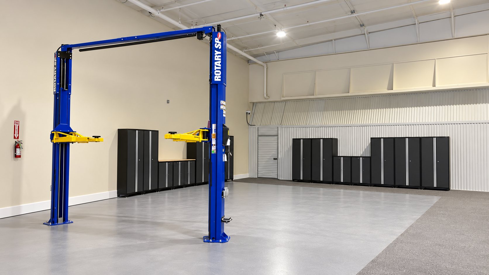 The ESS inspection bay with a two-post vehicle lift, epoxy floor, and storage cabinets